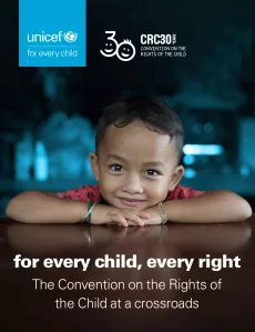 A photo of the cover image: a young boy is smiling with his hands and head on a table, the text is in the bottom third of the image: "for every child, every right The Convention on the Rights of the Child at a crossroads" and the CRC30 and UNICEF logos in the top third of the image.