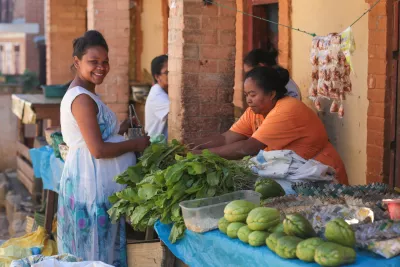 Razoeliarinala Tamby, 26, buys food at a market in Ambanitsena, Madagascar, 2019.