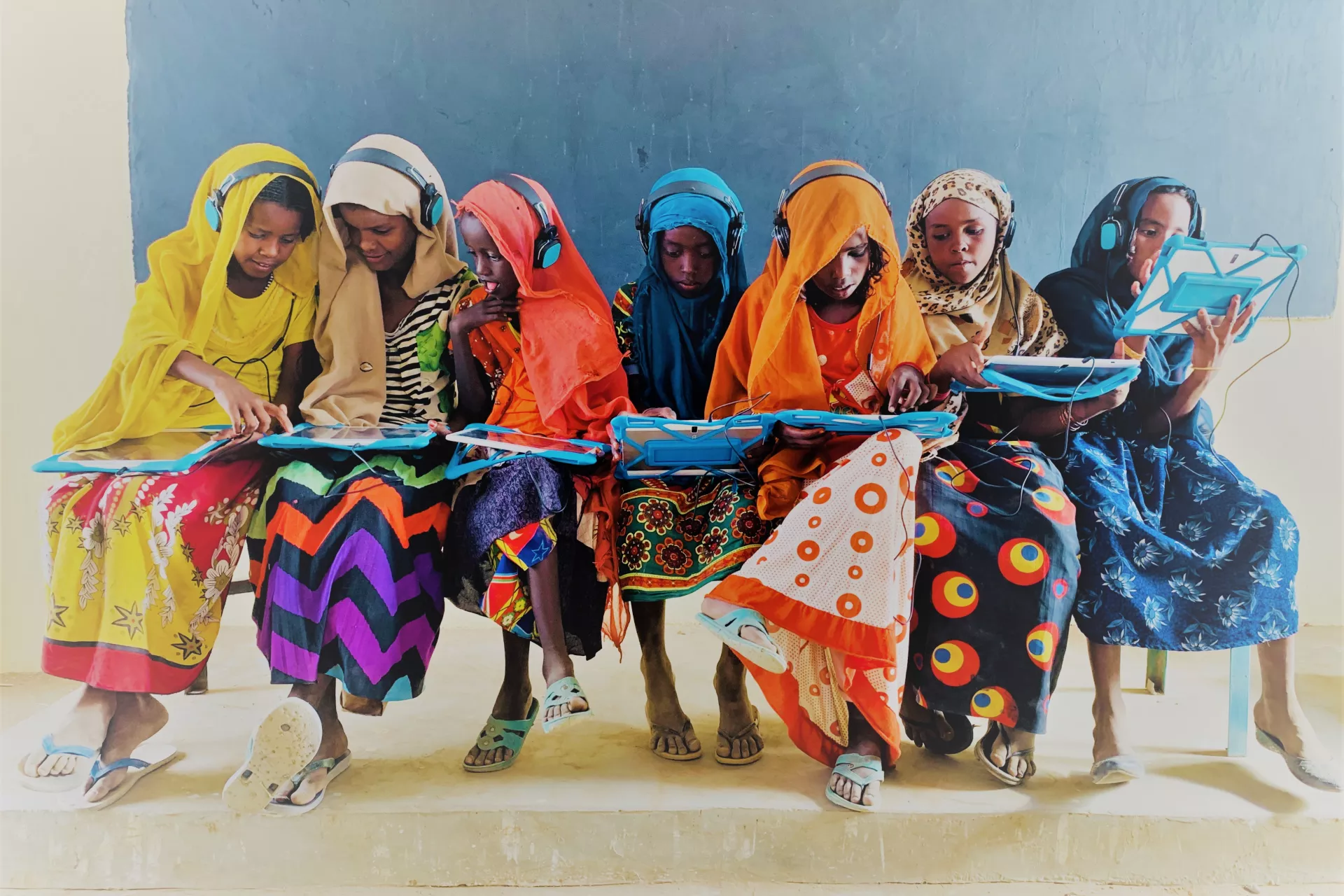 Group of girls using tablet computers to learn in Sudan.