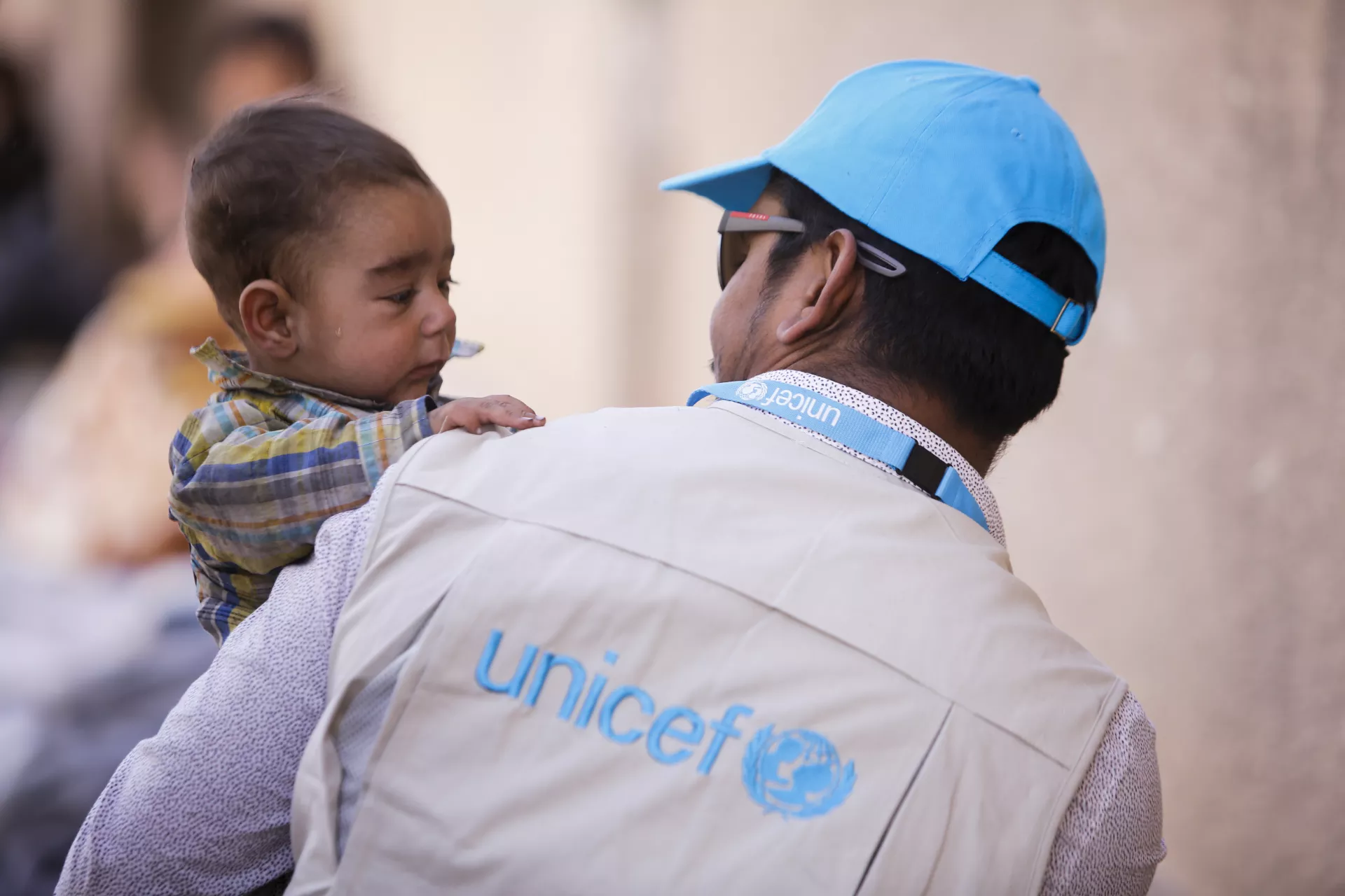 Convention on the Rights of the Child: A UNICEF child protection specialist holds a 6-month-old baby in Syria.