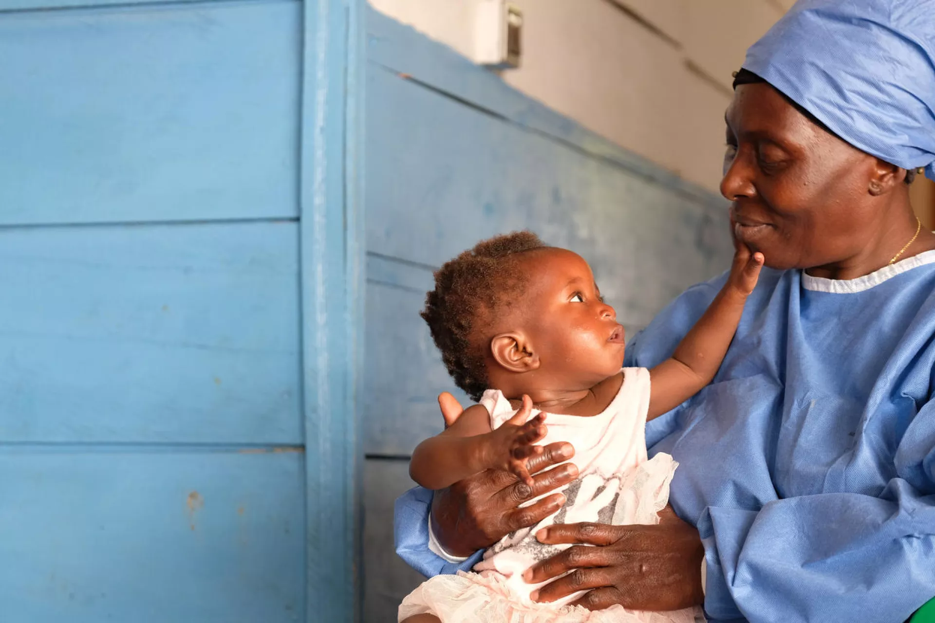 Democratic Republic of the Congo. An Ebola survivor looks after a child at a treatment centre.