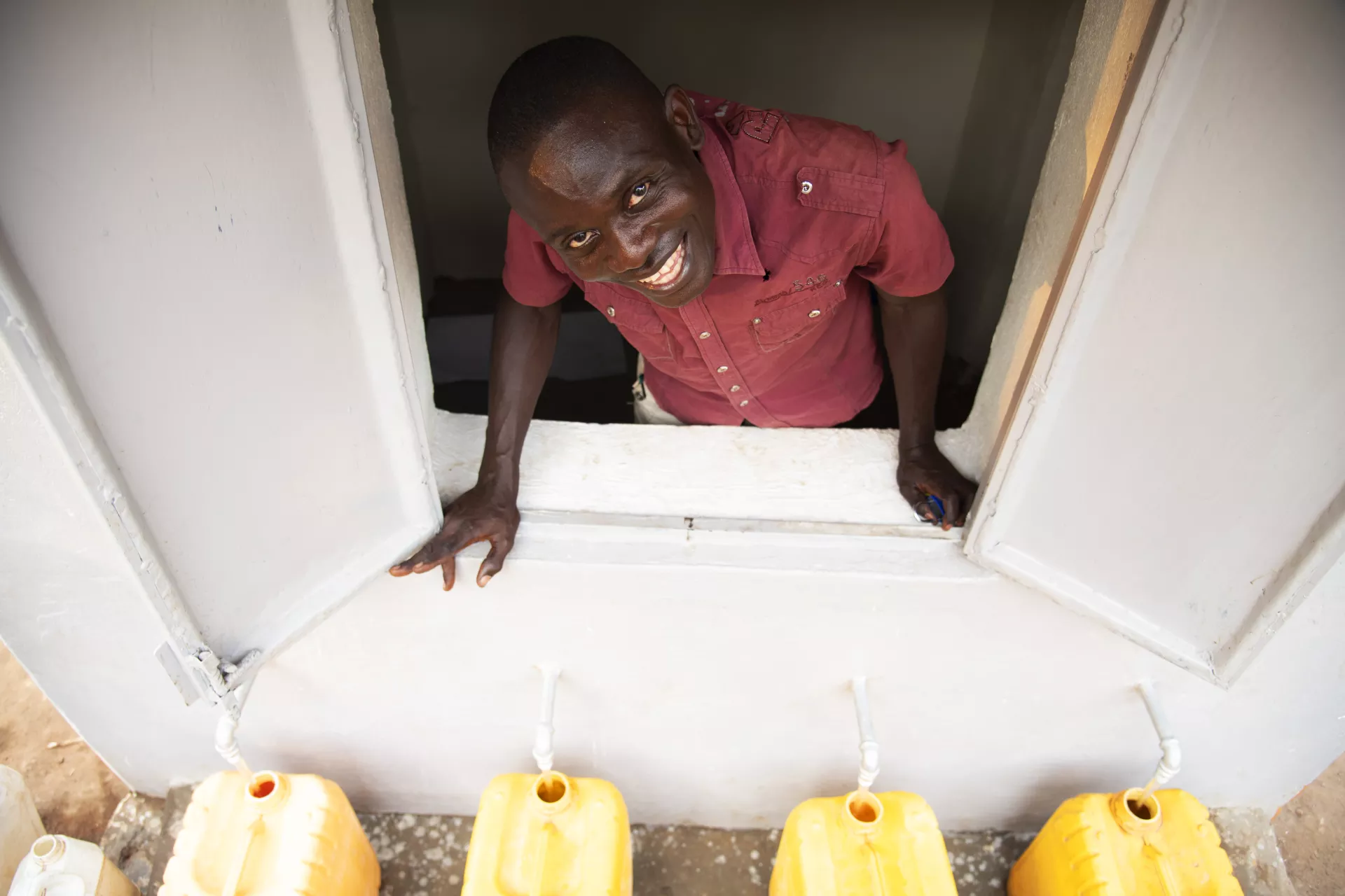 In South Sudan, UNICEF transformed an unprotected spring into a safe water source through the construction of a reservoir and treatment system and used solar systems to pump the water to tapstands, where the water is collected safely. 