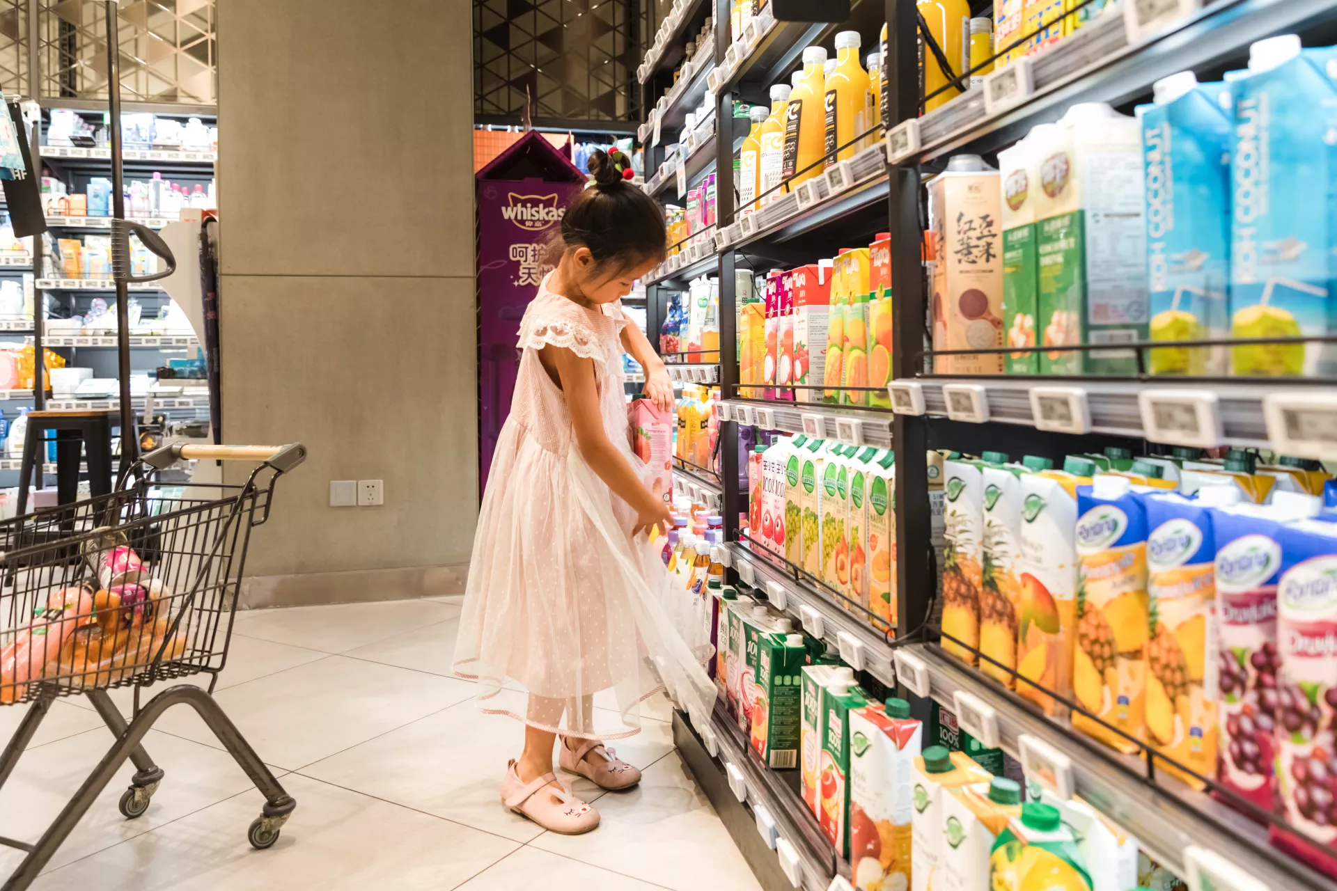 A girl in China picks up juice from store