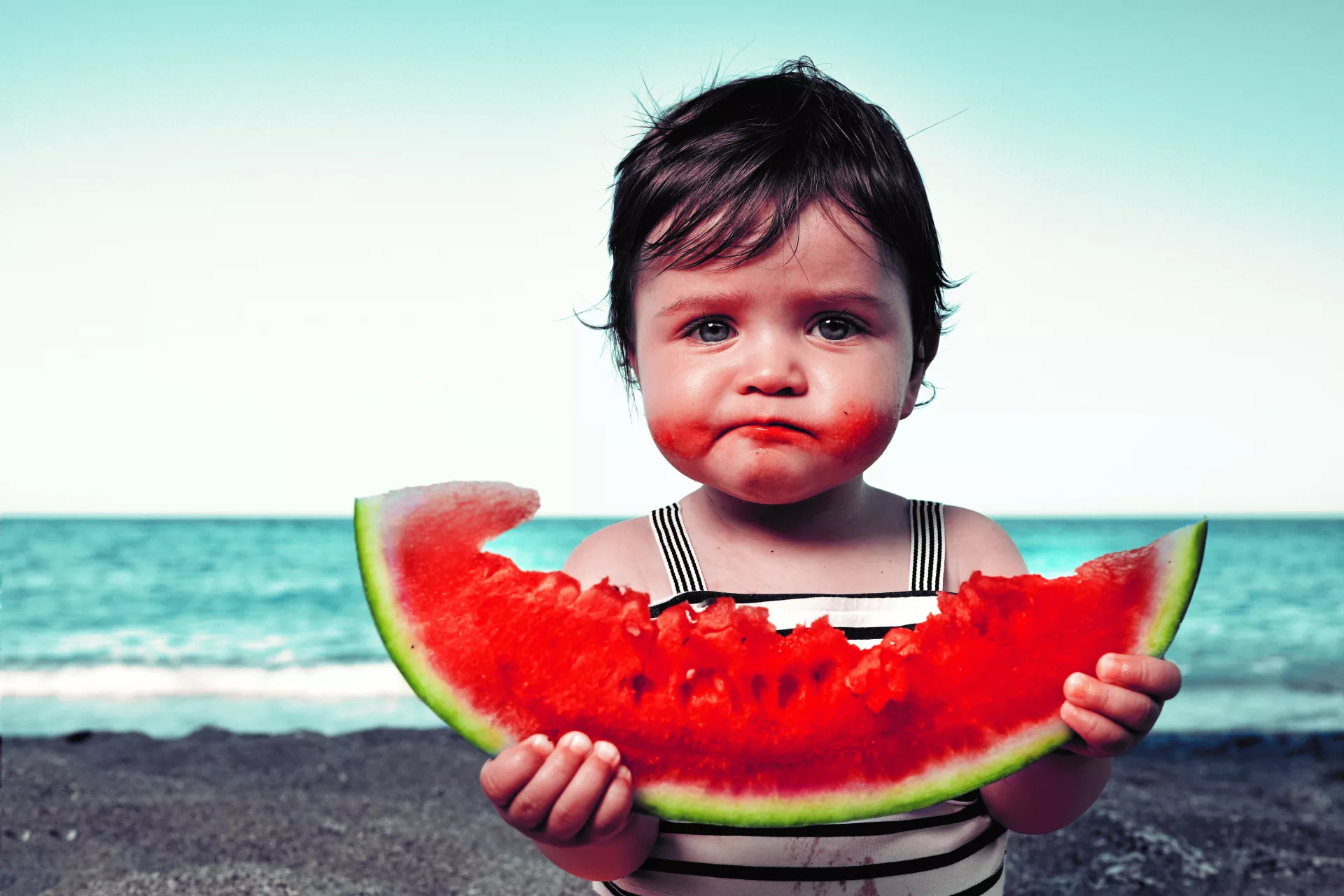 A child eating watermelon