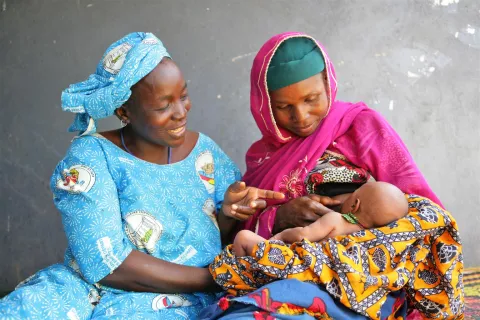 A woman breastfeeds her child, Niger