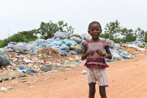 A girl playing in a landfill, Côte D'Ivoire