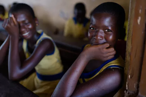 Two girls smile at school in Elmina, in the central region of Ghana, in May 2015.