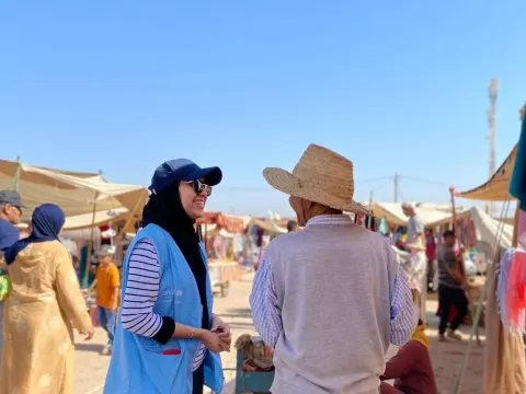 A young women speaks with a father about health in Souk Beni Ayat in the Azilal region.