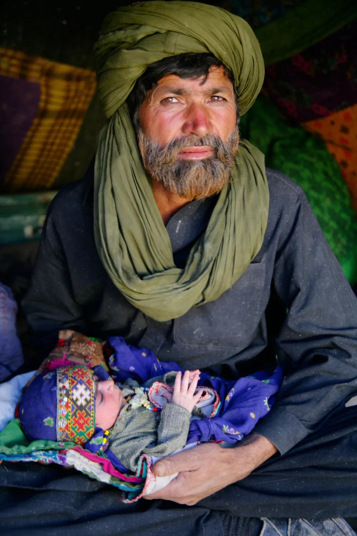 A man in Pakistan holds a child, in 2006.