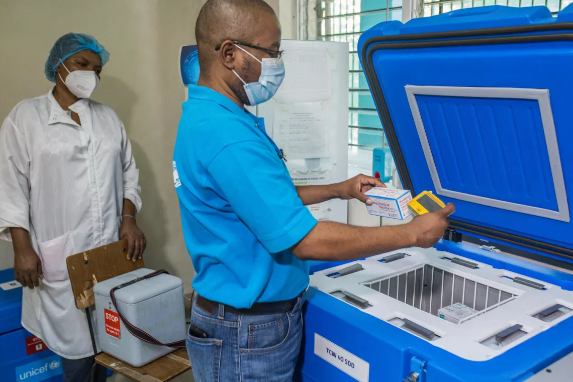 A box of Moderna vaccines are pulled from a solar storage refrigerator in Haiti's capital, Port-Au-Prince.