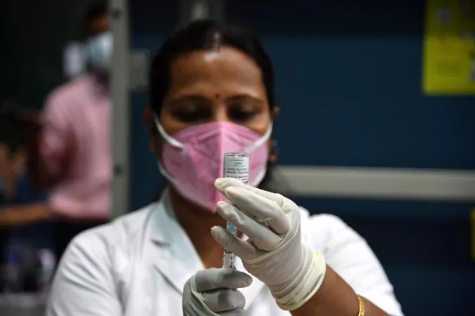 Healthcare worker prepares a vaccine for injection