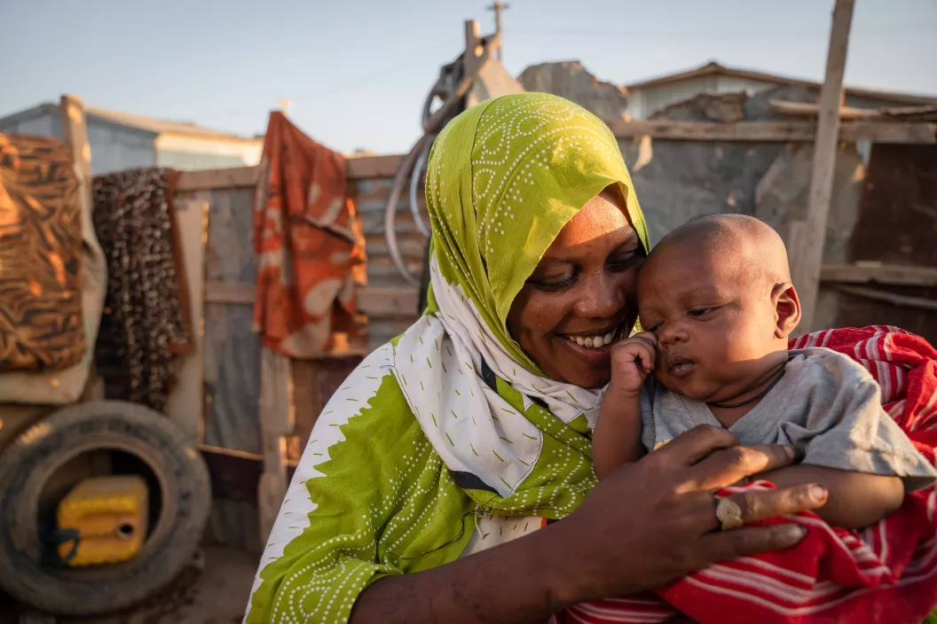 In Puntland, Somalia, mother Nasro Dire holds her 1-month-old son, Marwan Abdi, at their home in the Jawle camp for internally displaced people.