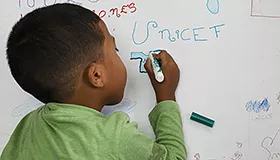 A boy draws during an art therapy activity in one of the protection centres supported by UNICEF in Venezuela, in 2019.