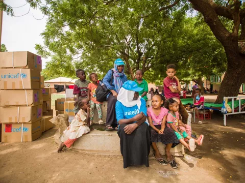 UNICEF staff engage with displaced children at a gathering point