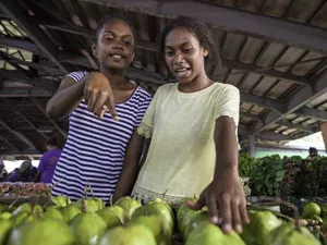 On 24 August, 2019, (left) Francina Sonitoga, 17, and Cecilia Vasuni, 16, buy guava fruits at Honiara Central Market, Guadalcanal, Solomon Islands.
