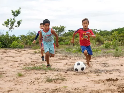 Children are playing football with their recreational kits in Venezuela