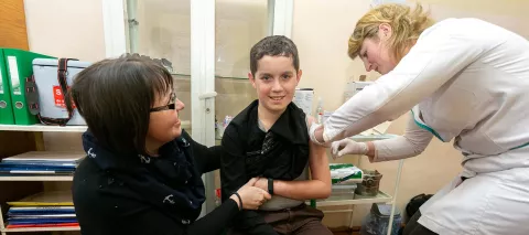 Ruslan Poliuga, 14, receive his MMR vaccine against measles, mumps and rubella from a mobile brigade of healthcare professionals on 26 February 2019 in Mykolaiv Gymnasium, Lviv region, Ukraine.