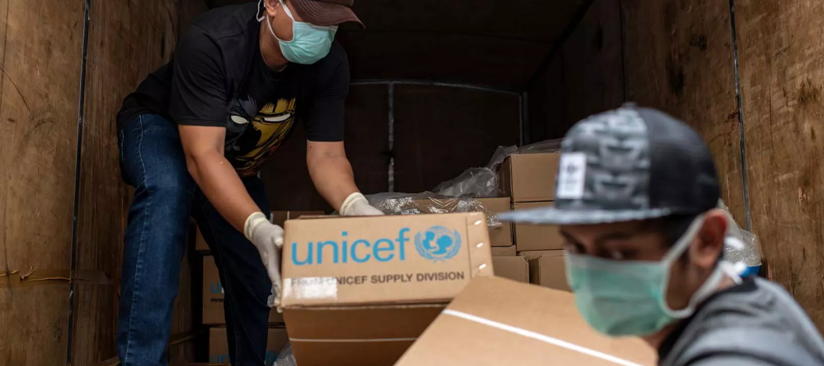 Health workers unload medical equipment from UNICEF Copenhagen's warehouse at the Ministry of Health warehouse in Jakarta on 22 March, 2020. 