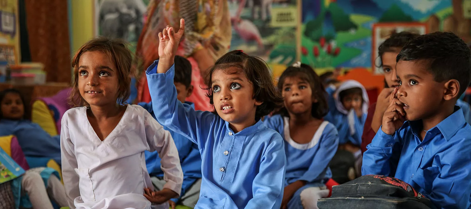  Five-year-old Minahil Muzaffar raises her hand in an Early Childhood (ECE) class in an elementary school in Toba Tek Singh district, in the Punjab province, Pakistan.