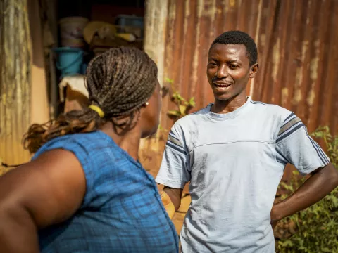 A man speaking to a woman in his community